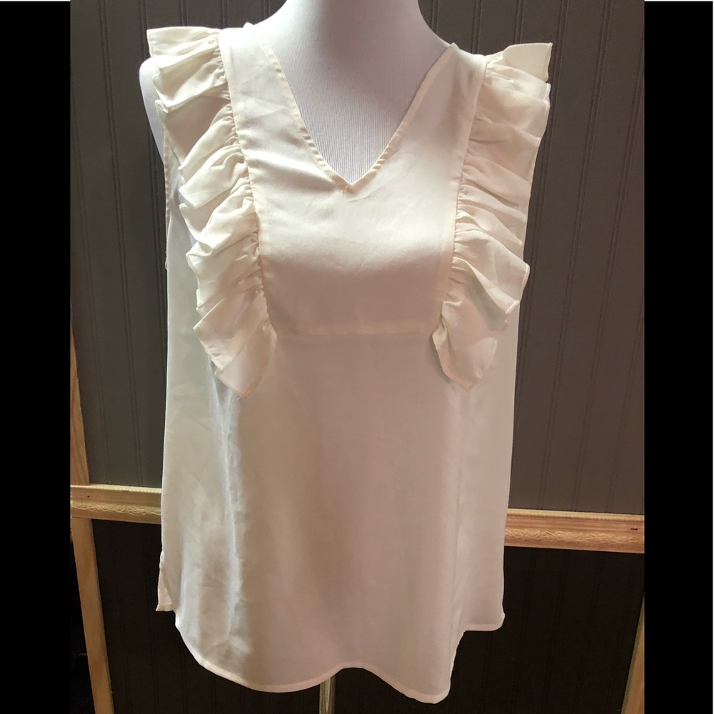 Ivory top, ruffled sleeves, the “Limited.”